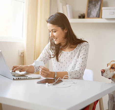 Young Caucasian businesswoman doing on on line payment woman checking a check online